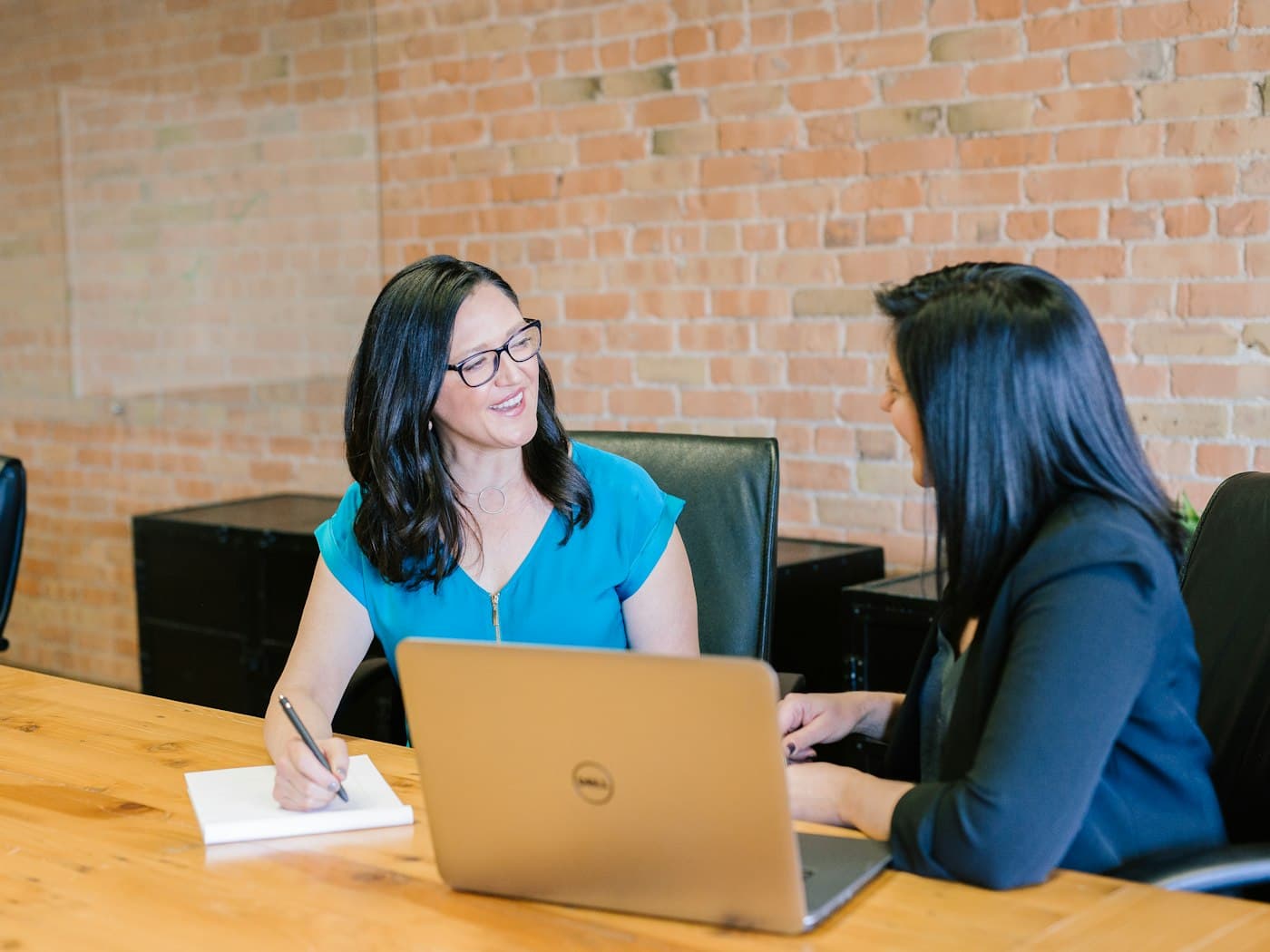 Two people reviewing policy details together at a table
